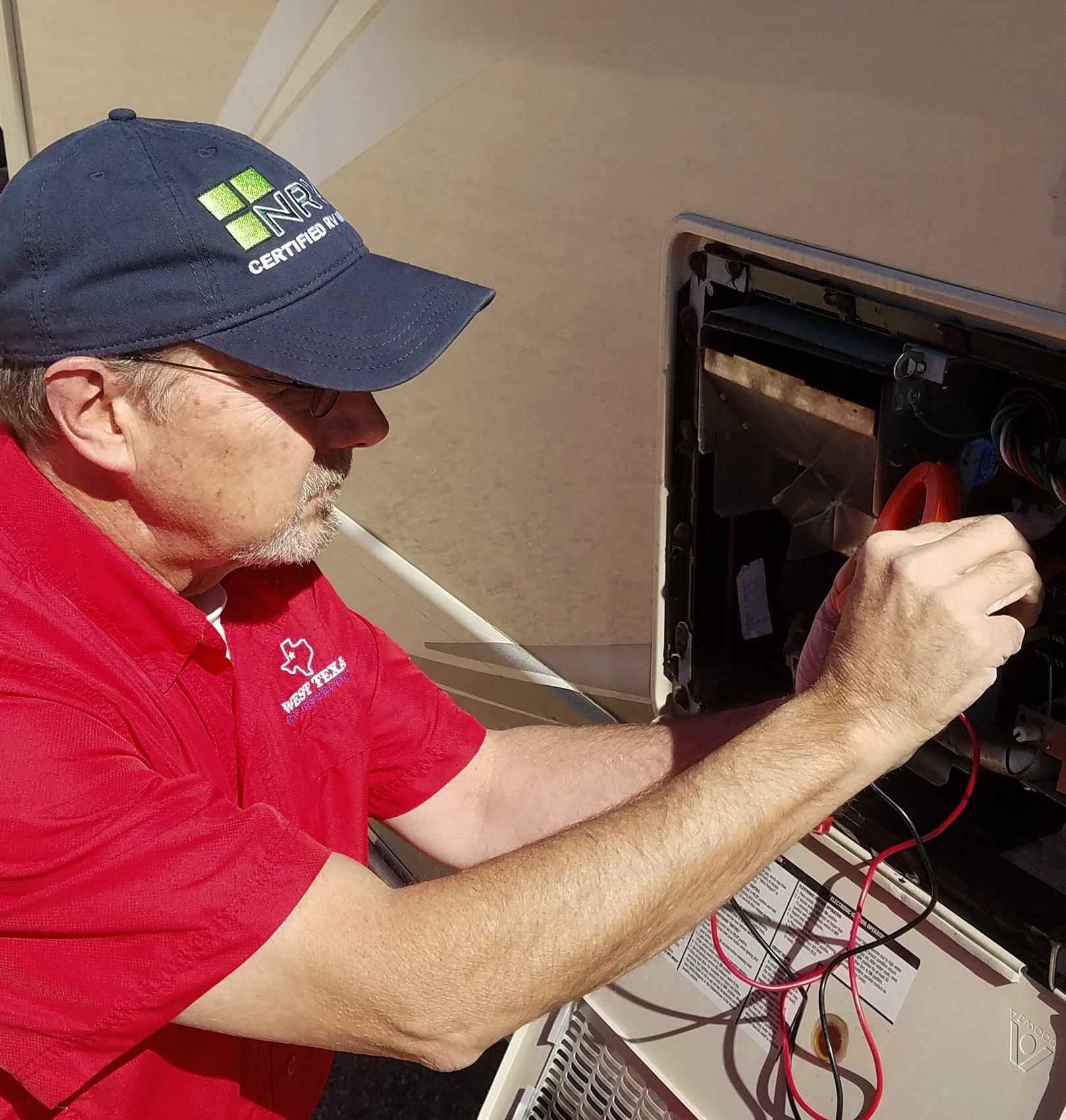 NRVIA Certified Inspector Wes Ward using a volt meter while preforming rv inspections services